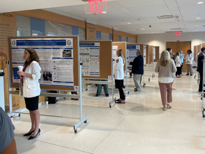 Photo of presentations being reviewed for UMMC OB-GYN Research Day 2024